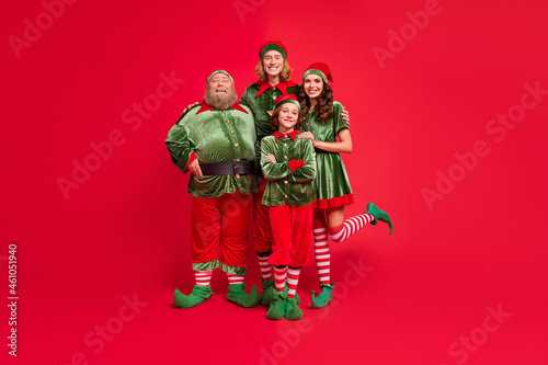 Full size photo of santa family people different shape hug wear new year cloth isolated on red color background