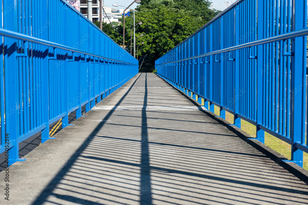 Blue pedestrian bridge with shadows. San Jose, Costa Rica.