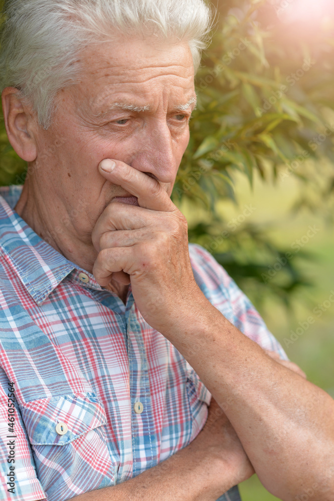Portrait of a thinking senior man in summer park Portrait of a thinking senior man in summer park
