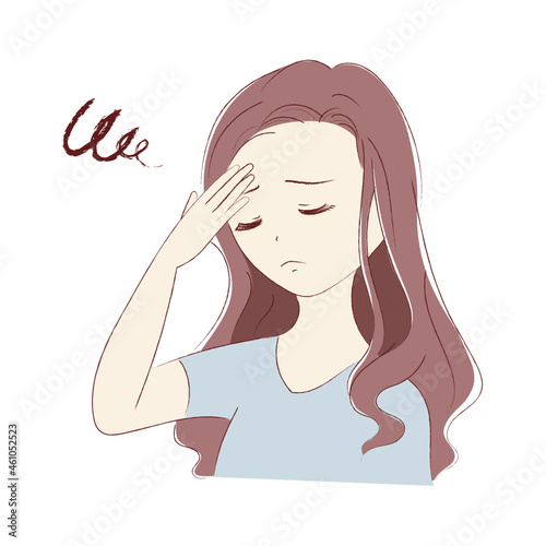 頭痛で額を押さえる若い女性