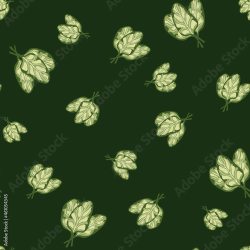 Seamless pattern bunch spinach salad on dark green background. Simple ornament with lettuce.