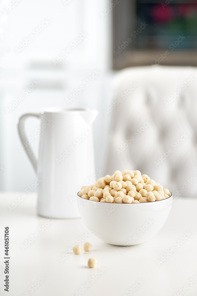 Healthy Breakfast of wheat balls with milk on a light table. selective focus Healthy Breakfast of wheat balls with milk on a light table. selective focus