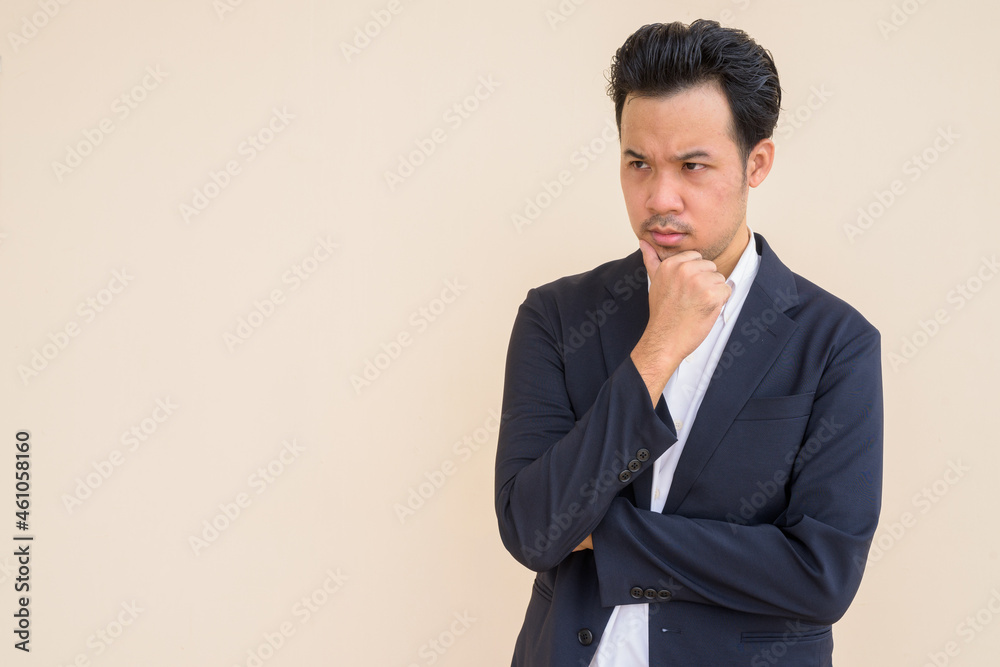 Serious Asian businessman thinking with hand on chin Serious Asian businessman thinking with hand on chin