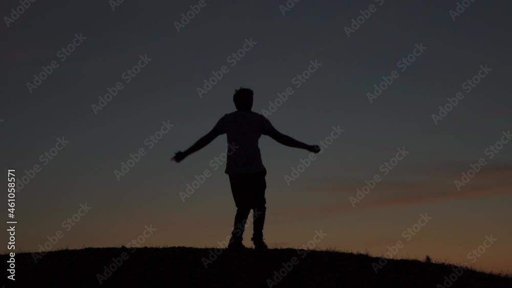 Silhouette of an Indian Man jumping and raising arms up on a peak after reaching at the top. Excited and happy man jumps in joy after the completion of the trek. Man is happy after a successful trek. Silhouette of an Indian Man jumping and raising arms up on a peak after reaching at the top. Excited and happy man jumps in joy after the completion of the trek. Man is happy after a successful trek.