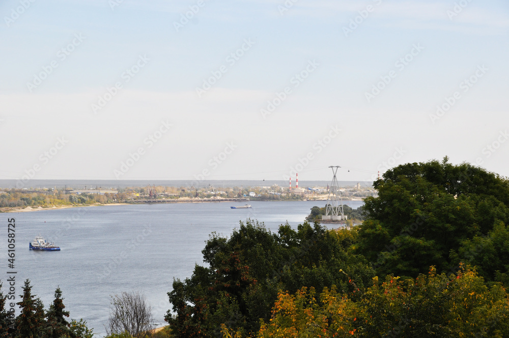 Panoramic view of the Volga river. View of the river, ship and houses on the opposite bank.