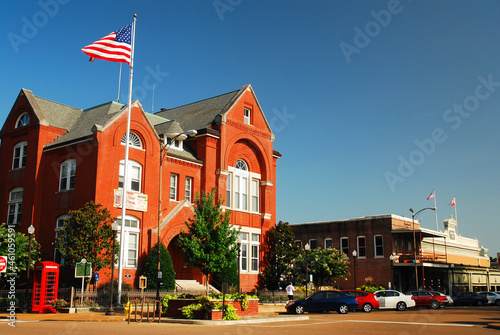 An American flag waves above the City Hall of Oxford, Mississippi photo