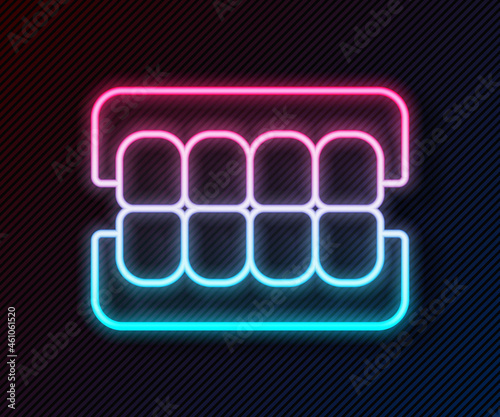 Glowing neon line False jaw icon isolated on black background. Dental jaw or dentures, false teeth with incisors. Vector