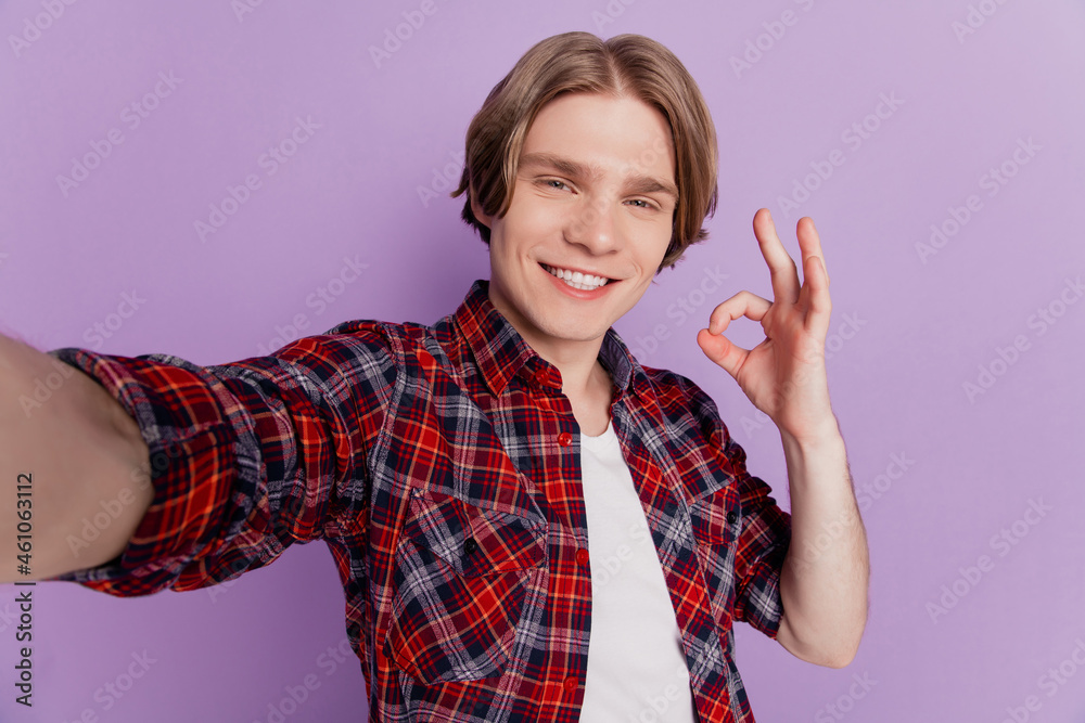 Portrait of cheerful nice attractive guy shoot selfie show okey sign on violet background Portrait of cheerful nice attractive guy shoot selfie show okey sign on violet background