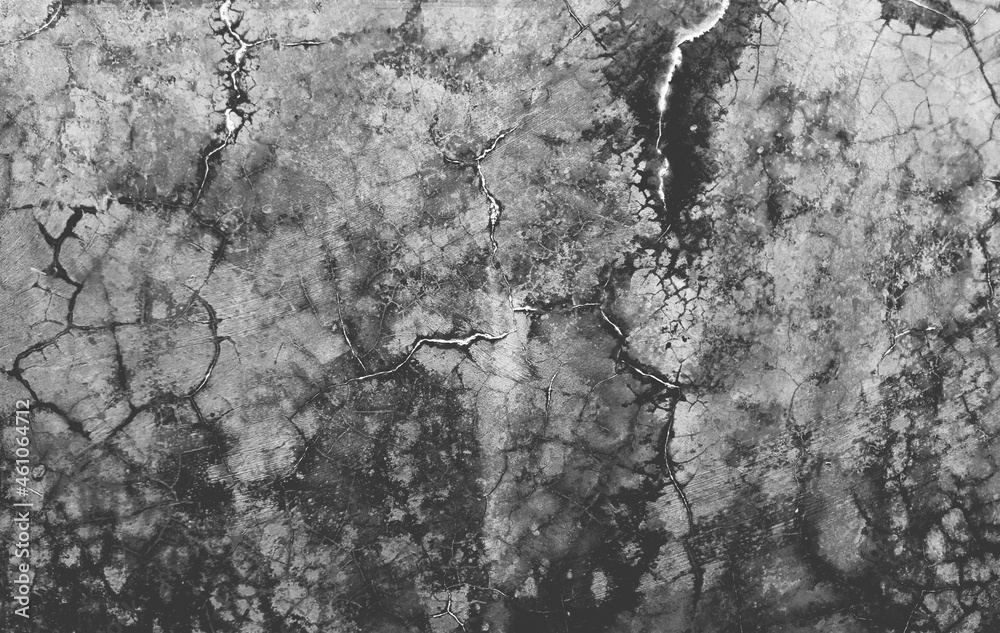 Dark gray cracks and wrinkled creases on old grainy paper in black