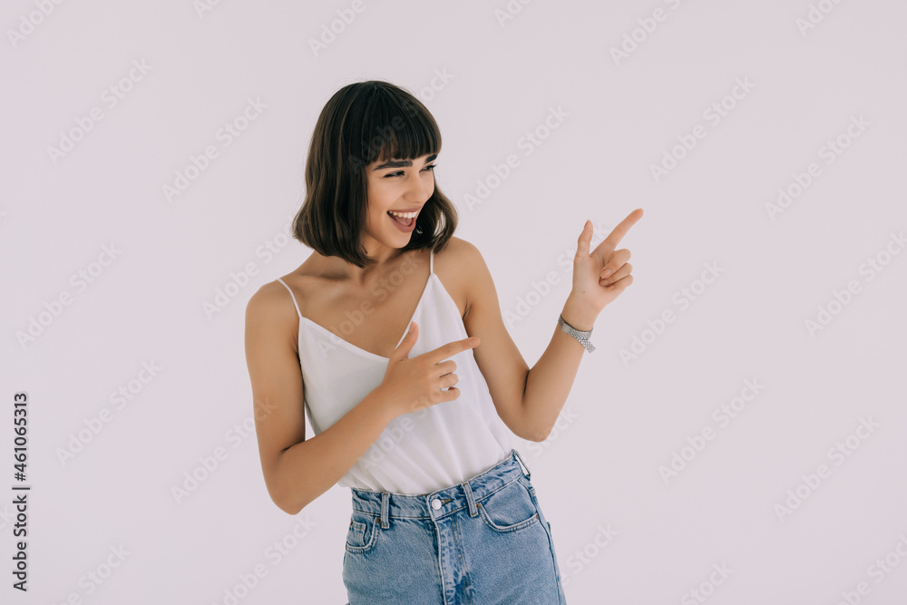 Smiling woman showing open hand palm with copy space for product or text isolated on white background Smiling woman showing open hand palm with copy space for product or text isolated on white background