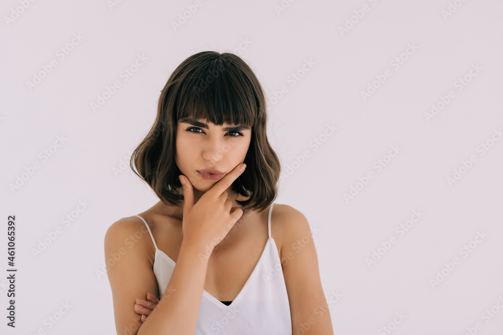Happy woman thinking and looking sideways on a white background Happy woman thinking and looking sideways on a white background
