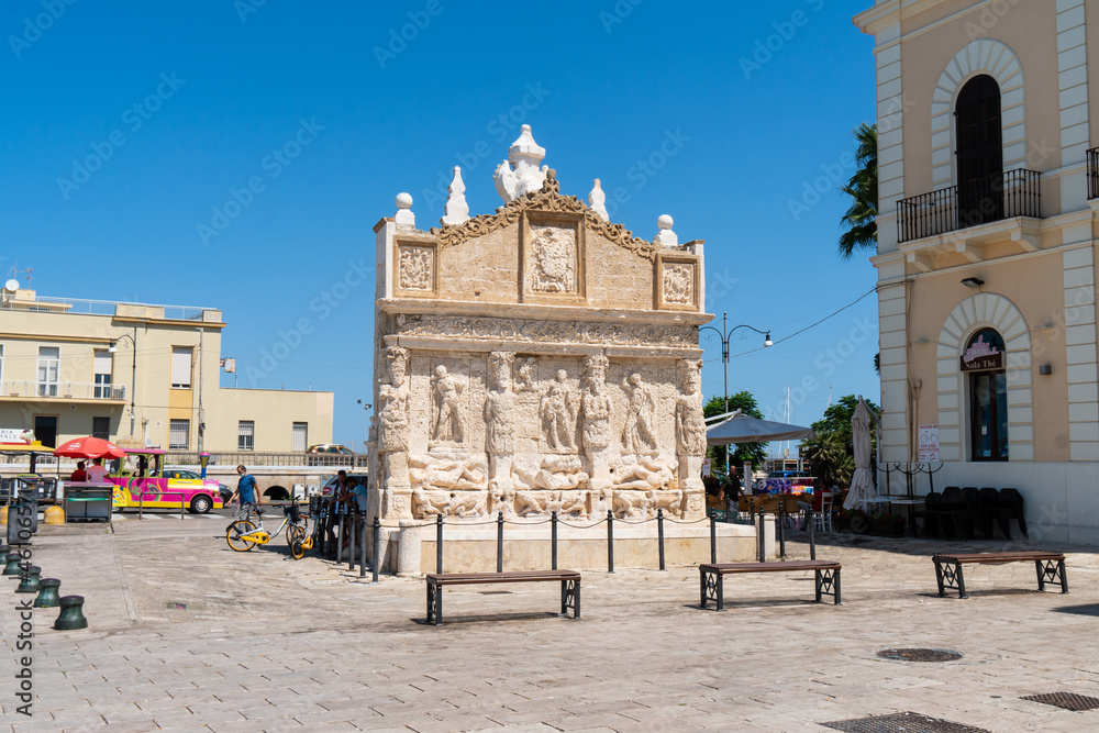 Gallipoli, Lecce, Puglia - August 20 2021: view of the Greek fountain near the bridge that connects the new town to the old town. This fountain is the oldest in Italy.