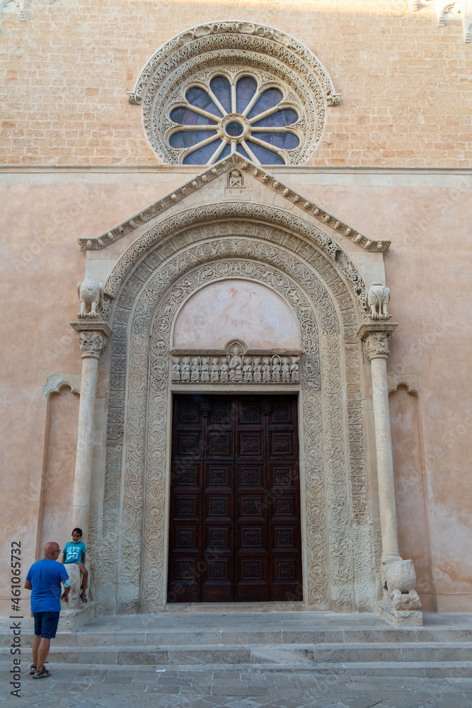 Galatina, Lecce, Puglia, Italy - August 19, 2021: detail of facade of the Basilica di Santa Caterina di Alessandria with the main door and the rose window