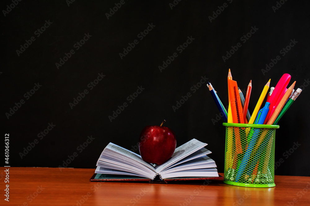 stationery box on brown table on black background