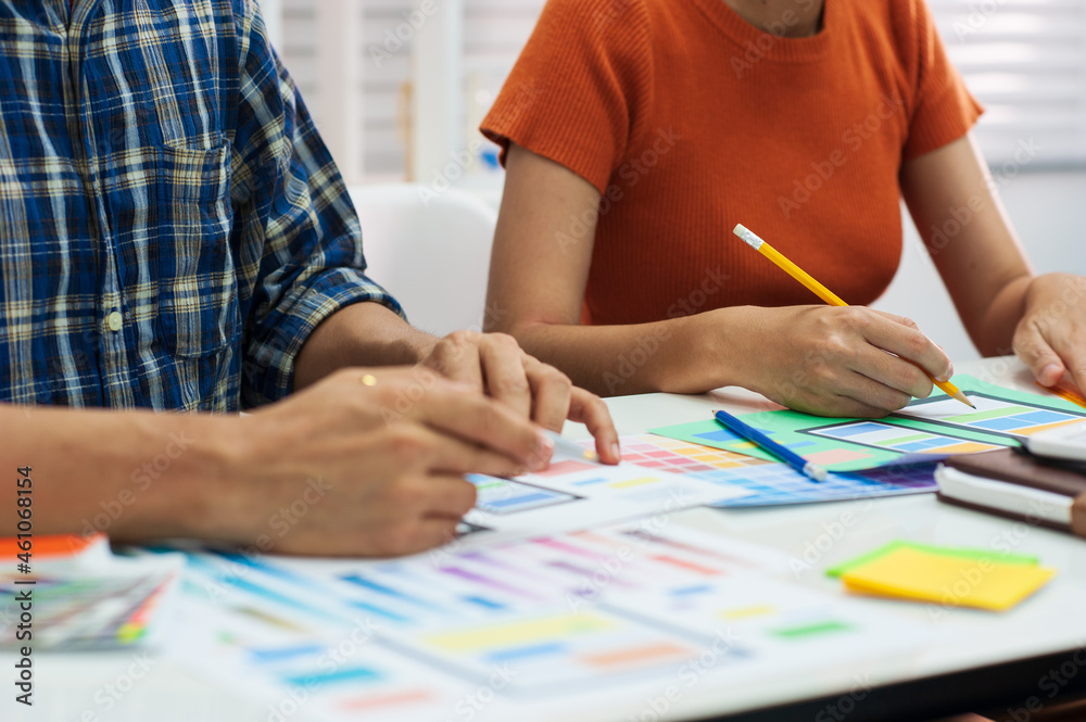 Two mobile application designers working at office desk. Two mobile application designers working at office desk.