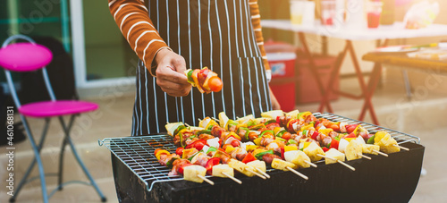 Prepare delicious barbecued food on the charcoal grill at an outdoor party.