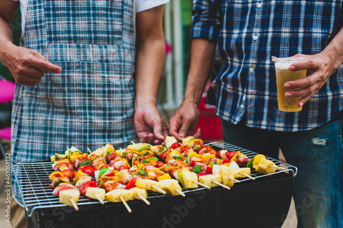 Man preparing food and barbecue for an outdoor party at home.