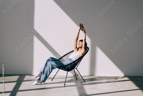 Young pretty woman resting in lounge chair at home