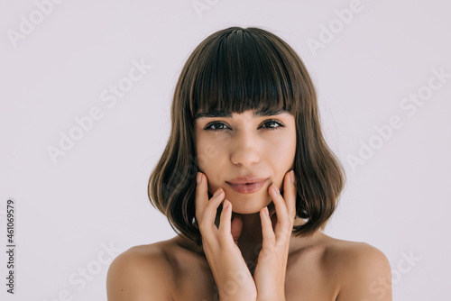 Beautiful sensual woman touching her face. Beauty and skincare concept. Spa.