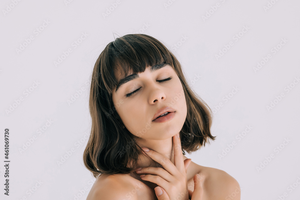 Beautiful Young woman touching her clean face with fresh healthy skin, isolated on white background. Beautiful Young woman touching her clean face with fresh healthy skin, isolated on white background.