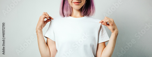 Photos Pretty plus size model with white blank t-shirt and pink hear, empty grunge wall background
