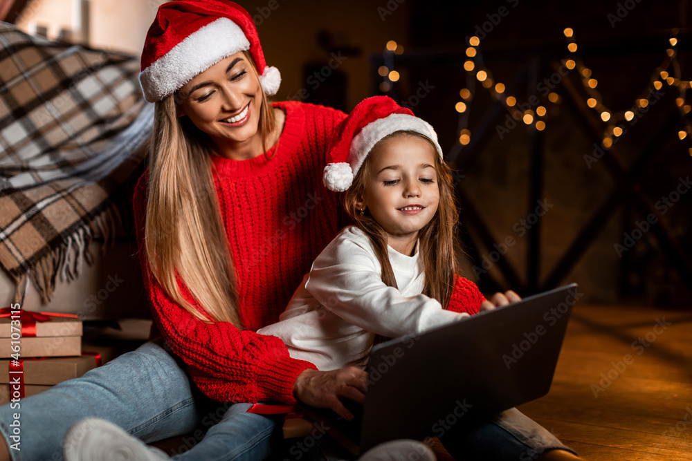 Portrait of happy festive woman and daughter using pc Portrait of happy festive woman and daughter using pc