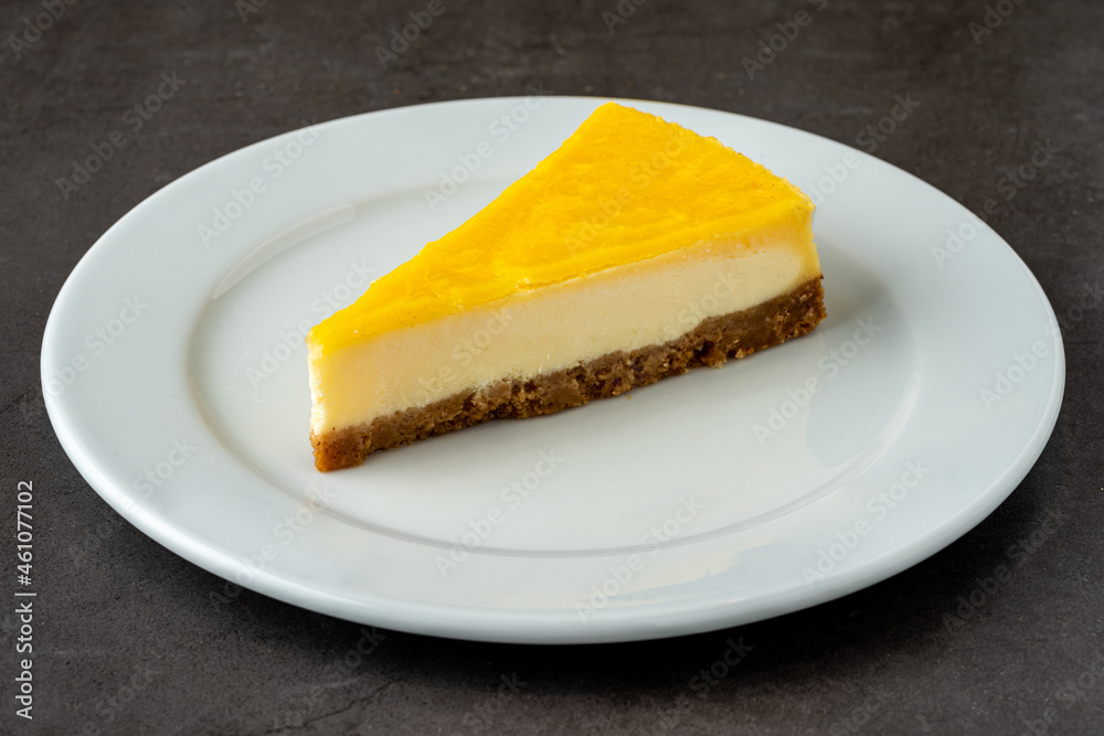 Delicious lemon cheesecake on black stone table Delicious lemon cheesecake on black stone table