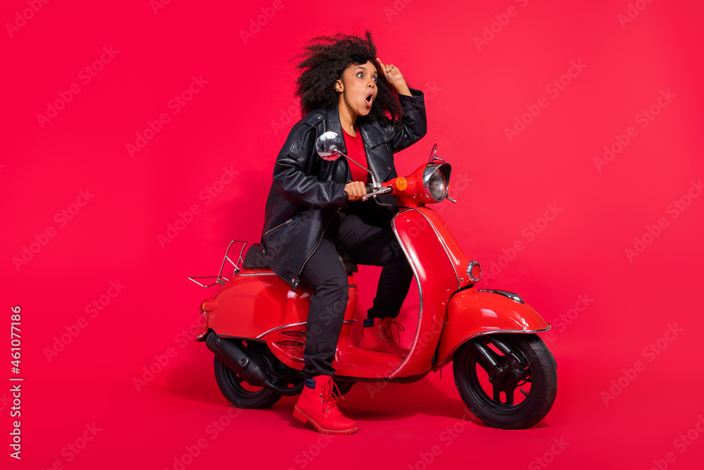 Full body profile portrait of impressed crazy lady look interested empty space open mouth isolated on red color background Full body profile portrait of impressed crazy lady look interested empty space open mouth isolated on red color background