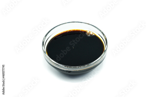 Soy sauce in glass bowl isolated on white background