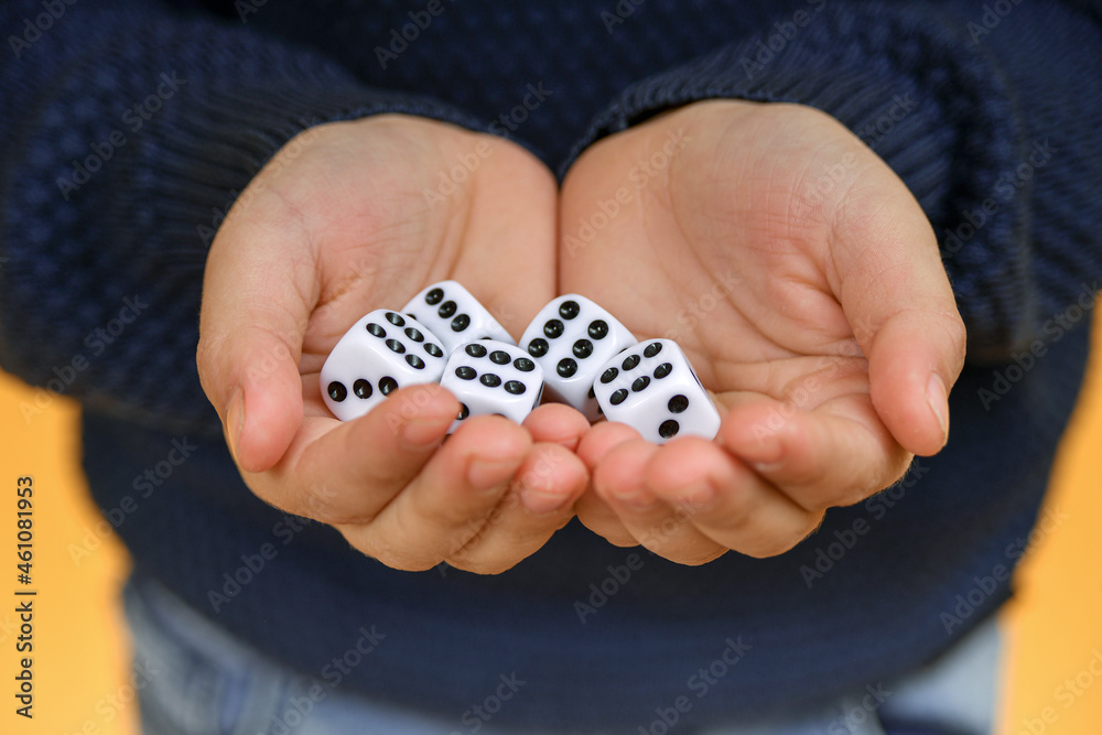 The dice are in the hand of the person offering to play the dice. The dice are in the hand of the person offering to play the dice.