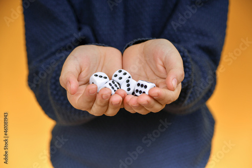 The dice are in the hand of the person offering to play the dice.