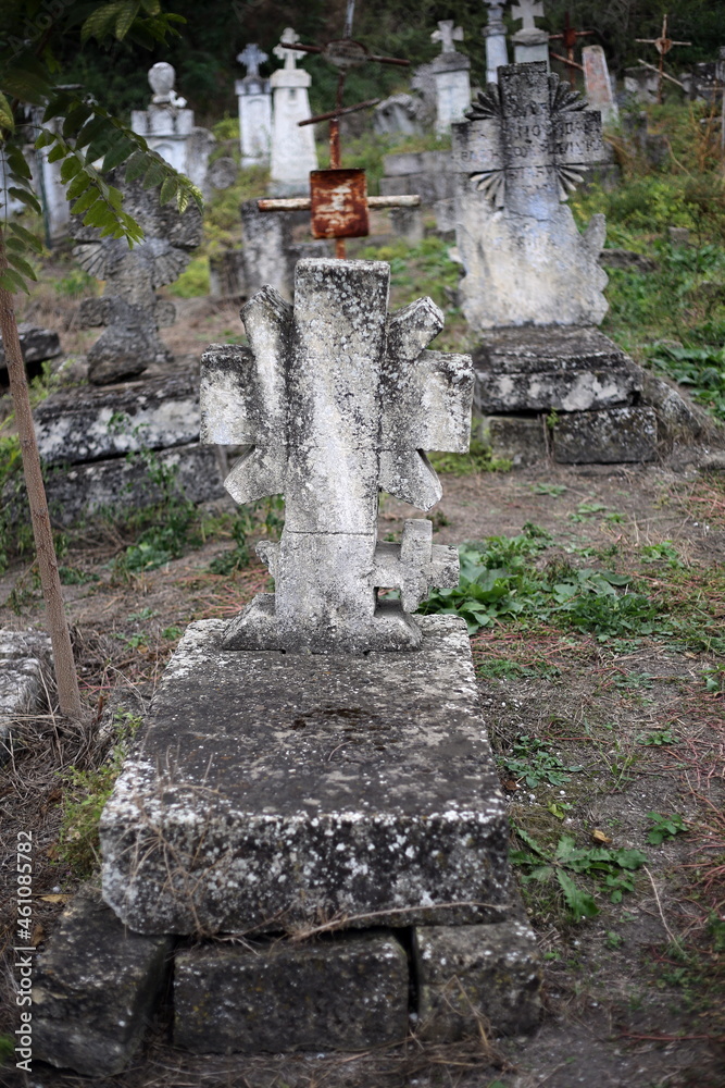 Fototapeta premium Old crosses and monuments in the cemetery. Unknown graves