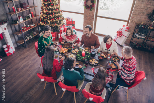 Photo portrait senior generation celebrating christmas with grandchildrean sitting at festive table eating dishes indoors apartment
