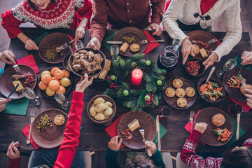 Top view photo family sitting at festive table eating delicious food celebrating winter holidays