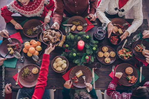 Top view photo family sitting at festive table eating delicious food celebrating winter holidays