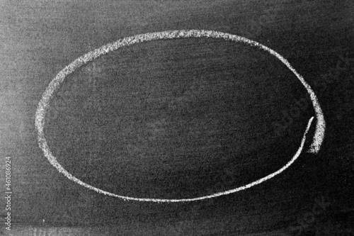 White chalk hand drawing as circle shape on blackboard or chalkboard background with copy space