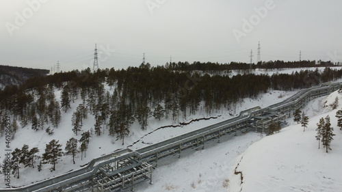 Large pipes filled with water go up the mountain to the state district power station in the city of Yakutsk. photo