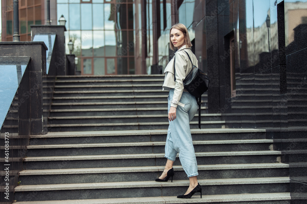 Portrait of a beautiful woman with a backpack on the stairs Portrait of a beautiful woman with a backpack on the stairs