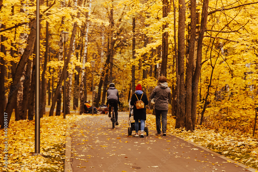 love, parenthood, family, season and people concept - smiling couple with baby pram in autumn park love, parenthood, family, season and people concept - smiling couple with baby pram in autumn park