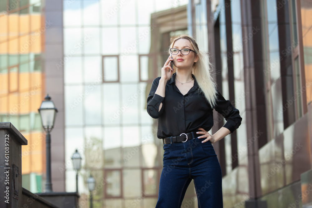 Young blonde woman talking on the phone in urban location. Lifestyle Young blonde woman talking on the phone in urban location. Lifestyle
