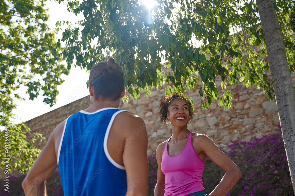 Cheerful sporty couple standing together outdoors Cheerful sporty couple standing together outdoors