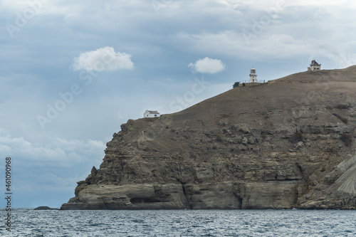 lighthouse at Cape Meganom in Crimea in cloudy weather photo