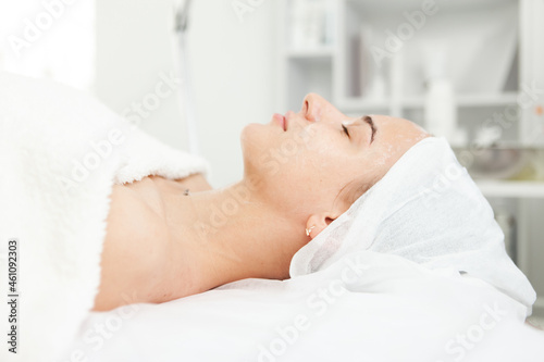 Portrait of a beautiful Caucasian woman lying on a couch at a cosmetology reception. Cosmetology procedures. Facial skin care