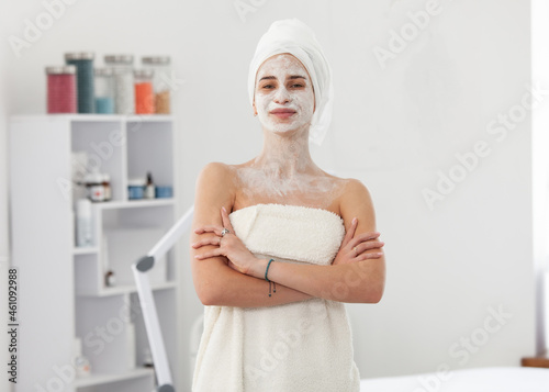 Beautiful woman with facial mask in beauty salon. Skin care concept
