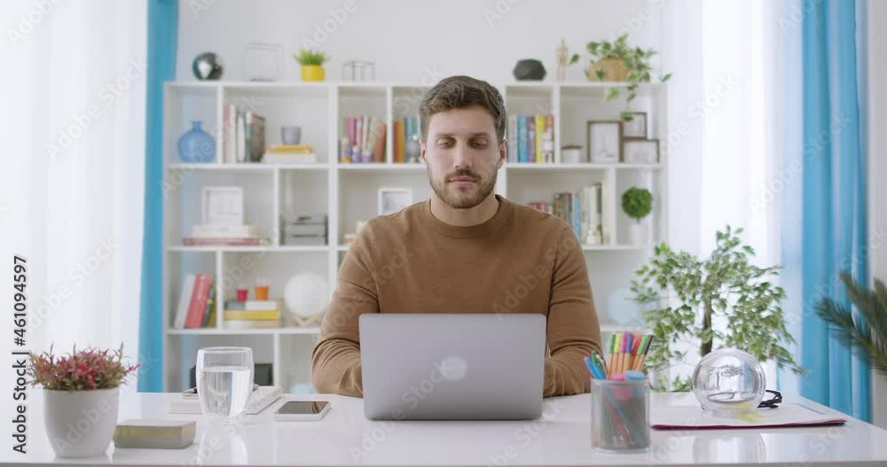 Dolly Out of Confident Handsome Caucasian Brunette Man Opening and Typing on Laptop, Young Bearded Male Professional Writing an Important Email From his Home in Modern Living Room. Remote Working Dolly Out of Confident Handsome Caucasian Brunette Man Opening and Typing on Laptop, Young Bearded Male Professional Writing an Important Email From his Home in Modern Living Room. Remote Working