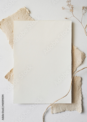 Handmade paper and dry flowers. Christmas Mockup for showcasing artwork and design. Minimal winter mockup of letterhead or drawing paper. Flat lay.