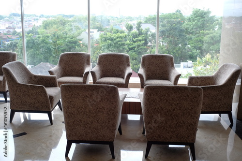 Yogyakarta  Indonesia  Oct 5  2021. Set of chairs and tables for guests or visitors to relax in a hotel lobby with a large glass window as the background. 