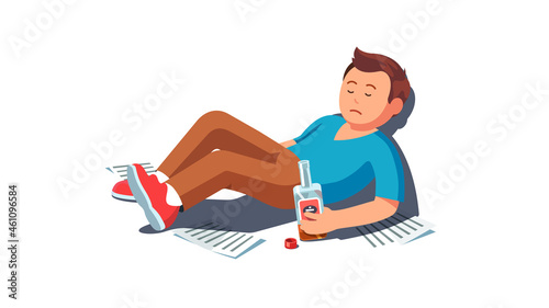 Sad drunk man lying holding whiskey alcohol bottle