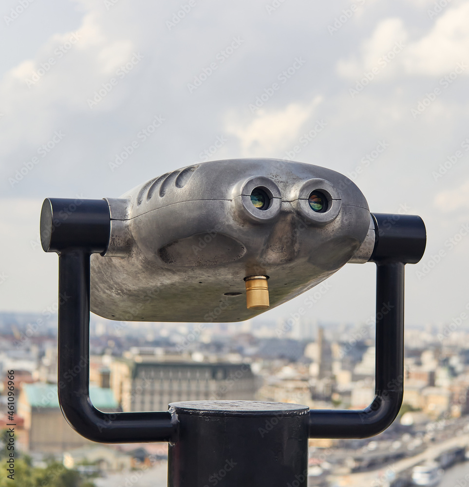 Binocular. Blurred background of the city of Kyiv. 