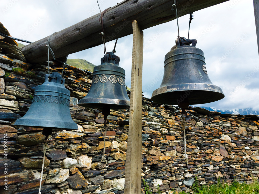 Obraz premium The old bells of Lamaria church next to the huge stone fence Ushguli Georgia.